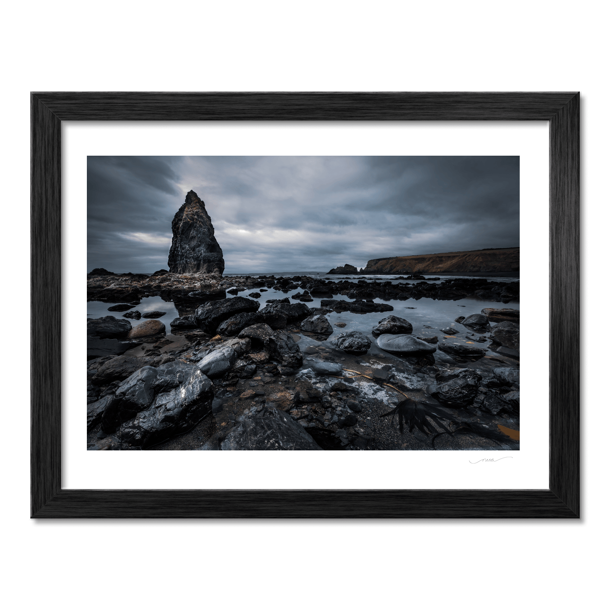 dramatic-sea-stack-rocky-shore-moody-skies PM