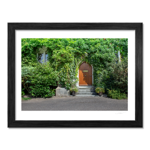 Ivy-Covered Cottage with Arched Wooden Door, Co. Cork fine art photography print by Nua Photography