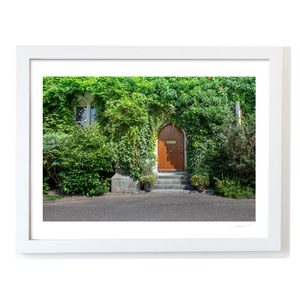Ivy-Covered Cottage with Arched Wooden Door, Co. Cork fine art photography print by Nua Photography