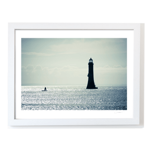 lighthouse-silhouette-shimmering-sea-down WF