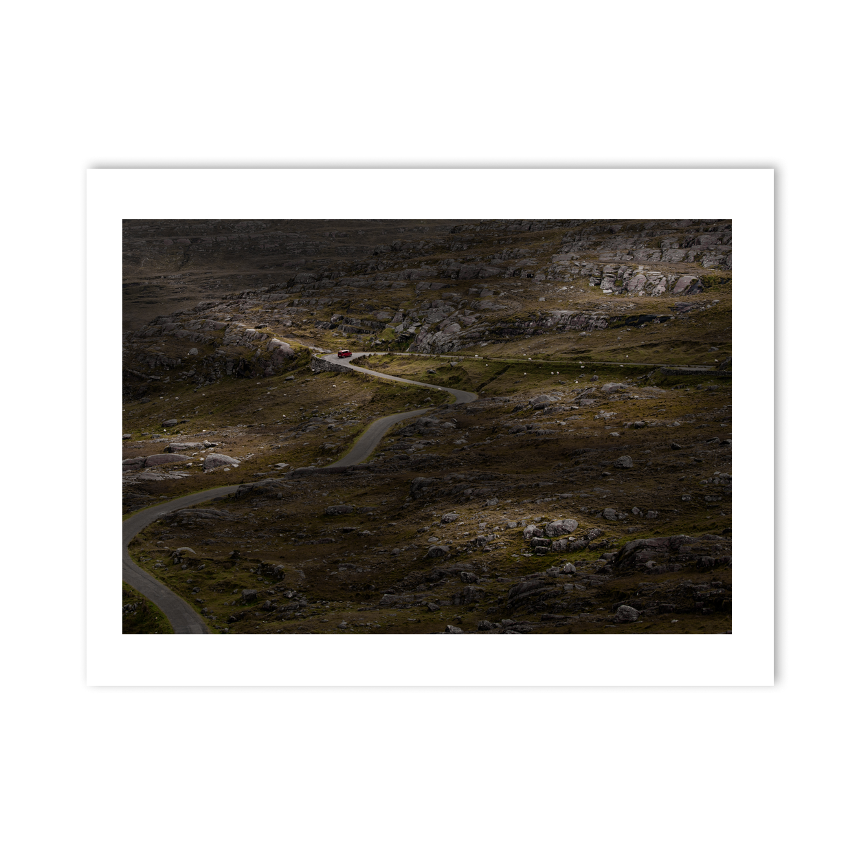winding-road-through-rocky-moorland-red-van PM